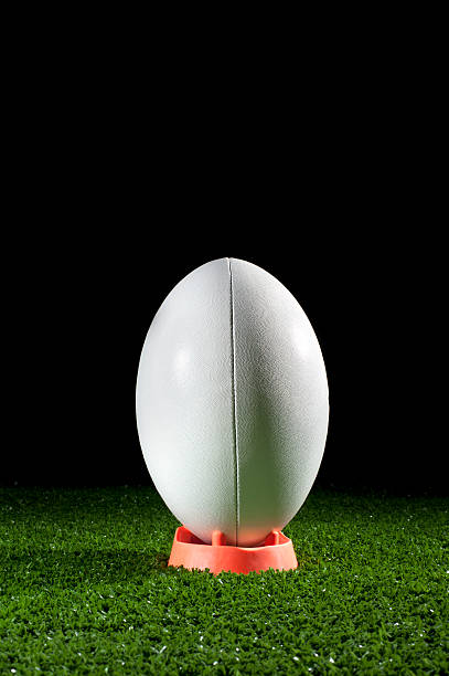 istock White rugby ball on a tee in grass 184384748