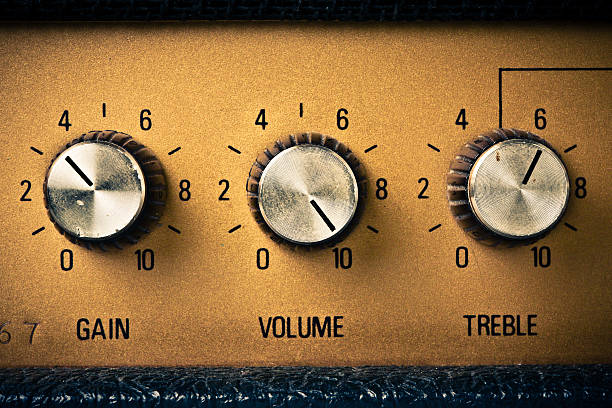 Silver gain, volume, and treble knobs on gold amplifier Volume knob to the max on a guitar amplifier. Retro mood. volume knob photos stock pictures, royalty-free photos & images