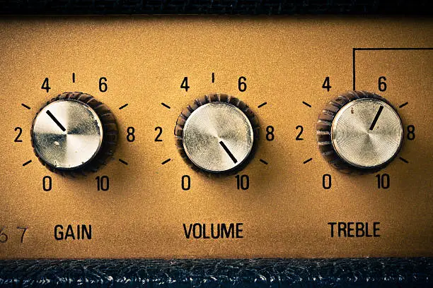 Volume knob to the max on a guitar amplifier. Retro mood.