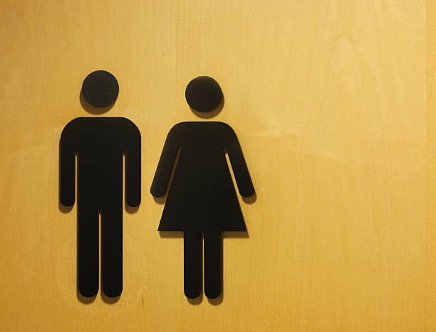 Male and female restroom symbol. Male and female restroom symbols on maple doorway. public restroom photos stock pictures, royalty-free photos & images