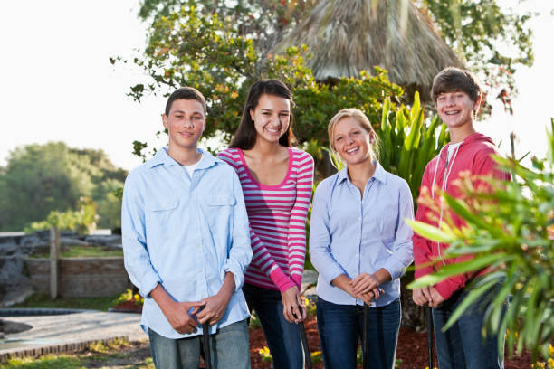 istock Teenagers playing miniature golf 184385230