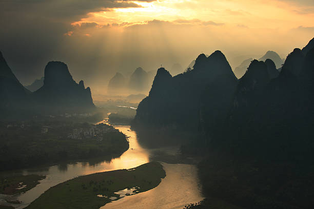 Guilin Hills in Mist at Sunrise "Guilin Hills in Mist at Sunrise,guilin,chinaPlease refer to my other Yangshuo pictures,thanks." guilin hills stock pictures, royalty-free photos & images