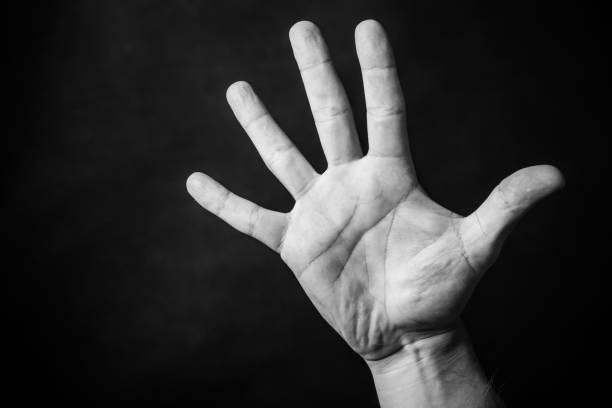 black and white hand reaching