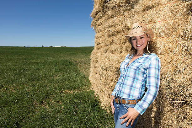 istock Cowgirl and Hay Bail 184386320