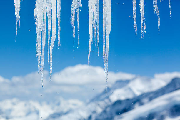 Icicles Icicles with mountain peaks in the background. icicles melting stock pictures, royalty-free photos & images