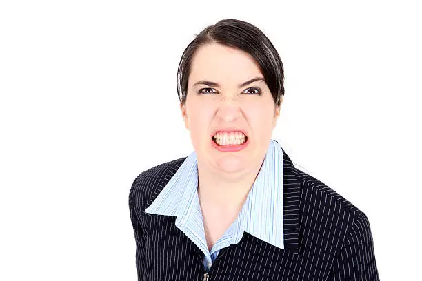 Business woman on white background growling in a pretty cheesed off way