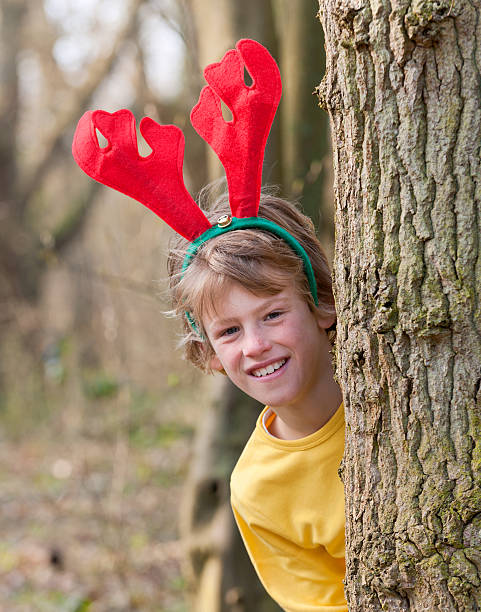 istock playful boy in forest at Christmas 184386974