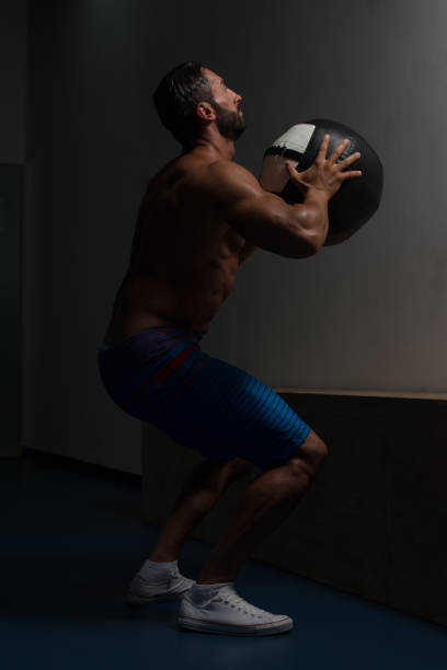 istock Muscular Man Doing Medecine Ball Exercises 1843870515