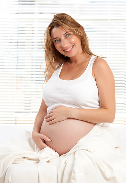 istock Pregnant woman on white bed. 184387079