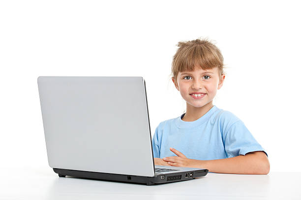 eight years old girl in front of computer isolated on white