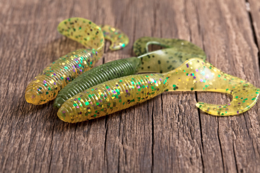 Soft fishing lures on wooden background; made of extremely soft rubber and silicone; argb color spacesee other similar images: