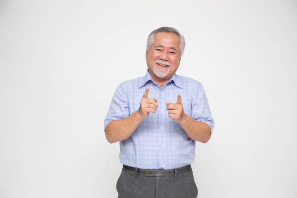 istock Happy Asian old man pointing to copy space blank space isolated on white background 1843906268