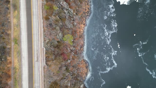 Drone footage of the cars driving on a narrow road along St. Croix River, Minnesota, USA