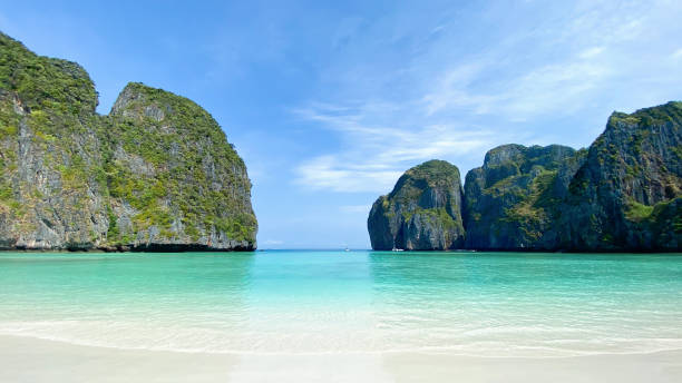 istock Tropical beach with rock mountain and blue sky background, 1843911005