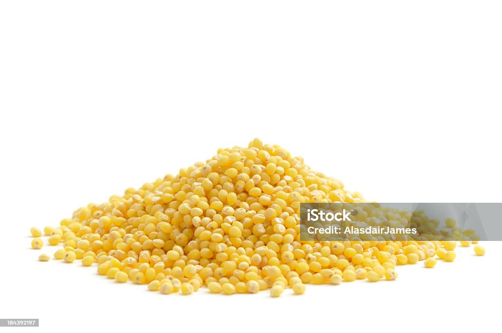 A pile of the food millet on a white background  Millets seeds isolated on a white background. Millet Stock Photo