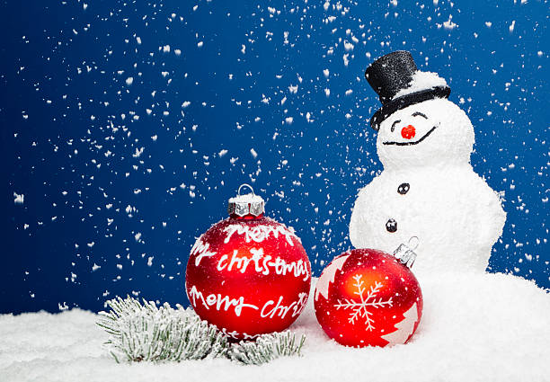 Xmas Snowman Christmas decoration in snow with snowman and Christmas bauble and pine branch. artificial snow stock pictures, royalty-free photos & images