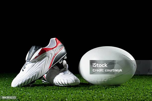 Rugby Ball And Boots On Grass Stock Photo - Download Image Now - White Color, Boot, Cleats