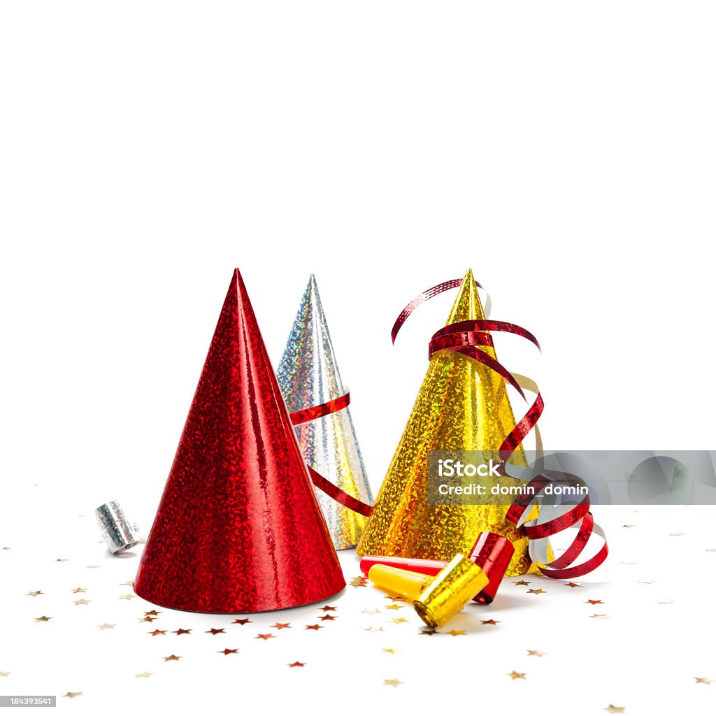 Multicoloured Party Hats isolated on white background, studio shot Party decorations: hats, whistles, streamers, confetti on white background. Square composition, copy space, studio shot. Party Hat Stock Photo
