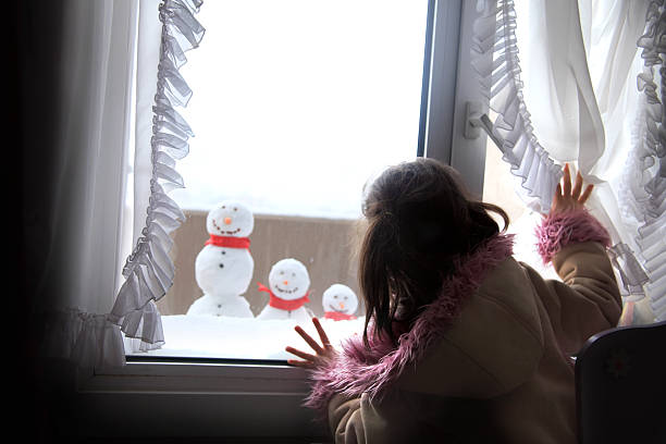 istock child and snowman 184393560