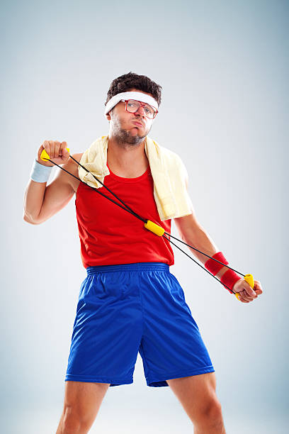 Portrait of funny sportsman working out with resistance band