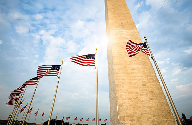 monumento de washington e bandeira americana - washington dc monument sky cloudscape imagens e fotografias de stock