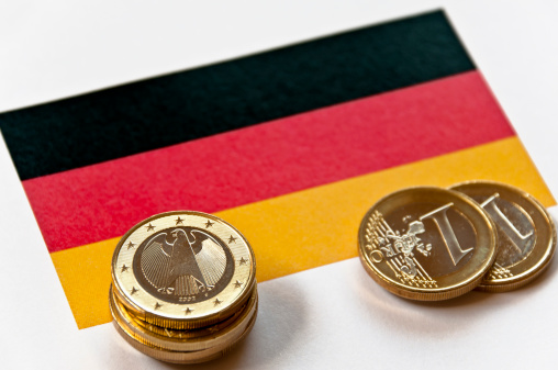 Close-up of a German flag and German euro coins. Focus is on the German euro coin.Similar images: