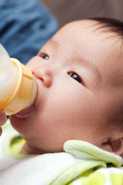 istock Asian Baby Feeding from a Bottle Vt 184394377