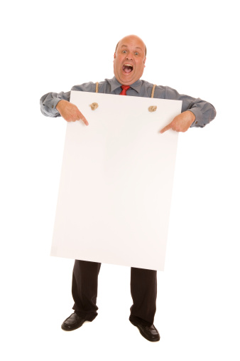 A man pointing to blank placard - add own text.