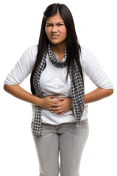 istock A photograph of a lady holding her stomach while grimacing 184394513
