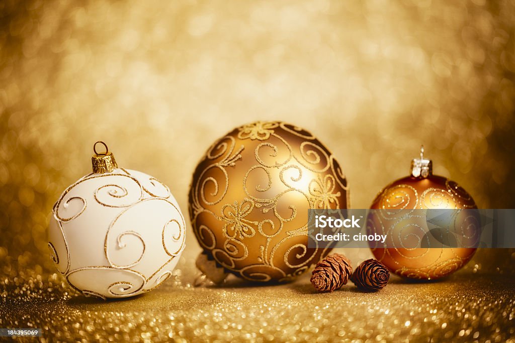 Glittery Christmas Baubles Golden Christmas decoration with Christmas baubles on defocused golden glittery background - selective focus Bright Stock Photo