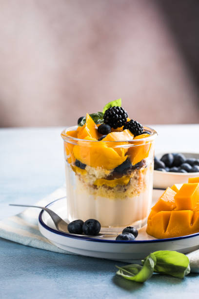 istock Trifle dessert with berries and cream on wooden table. Copy space 1843955605