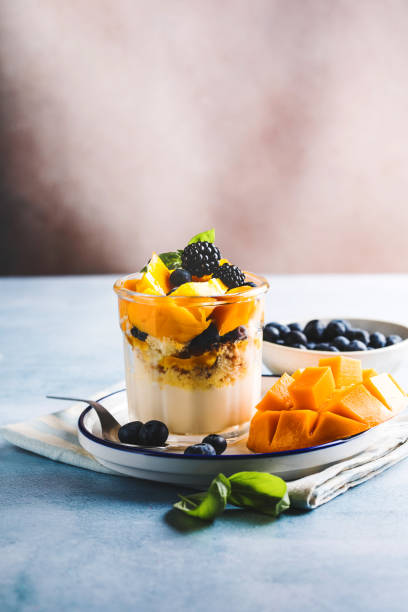 istock Trifle dessert with berries and cream on wooden table. Copy space 1843955606