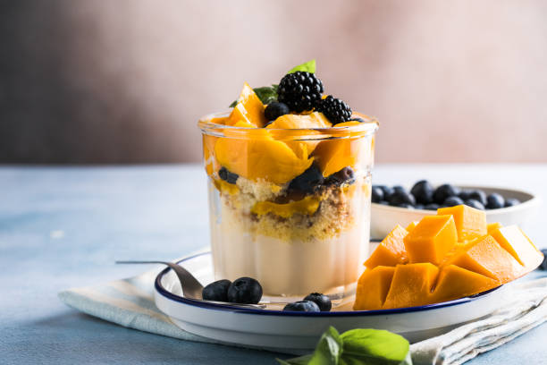 istock Trifle dessert with berries and cream on wooden table. Copy space 1843955609