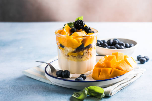 istock Trifle dessert with berries and cream on wooden table. Copy space 1843955610