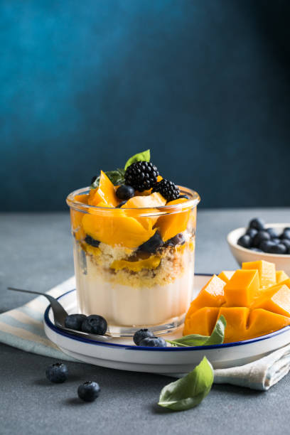 istock Trifle dessert with berries and cream on wooden table. Copy space 1843955611