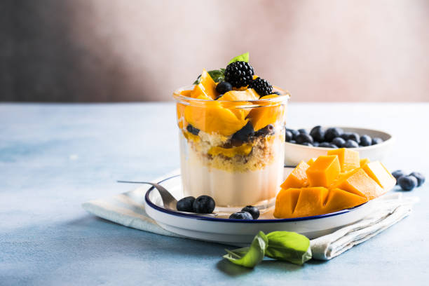istock Trifle dessert with berries and cream on wooden table. Copy space 1843955613