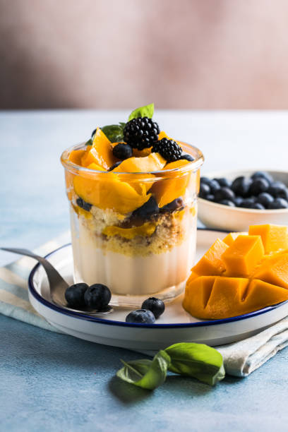istock Trifle dessert with berries and cream on wooden table. Copy space 1843955615