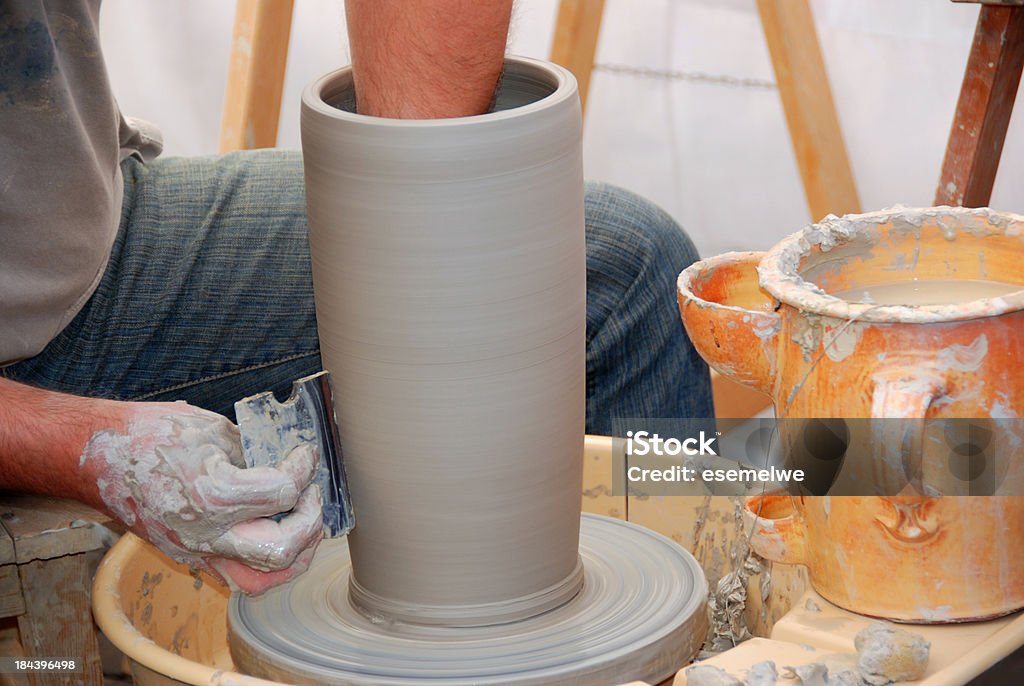Potter at work "Potter at work, shaping pottery as it turns on a wheel" Art And Craft Stock Photo