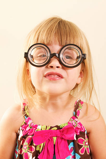 маленький nerdy girl in glasses - child cross eyed nerd eyewear стоковые фото и изображения