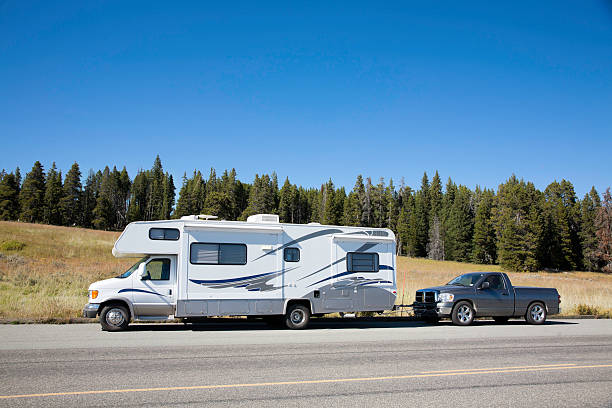 a truck and a travel trailer are parked in parking lot