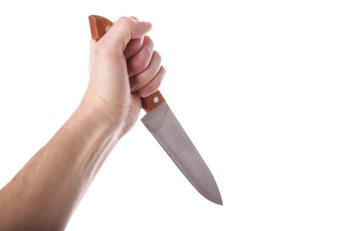 Kitchen knife on concrete background. Weapon or kitchen utensil.