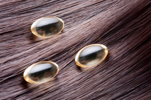detailed close-up of hair with gel capsules over itRelated images: