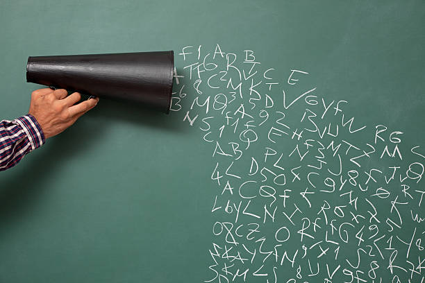 istock Megaphone with letters and numbers on blackboard for communication pollution 184397620