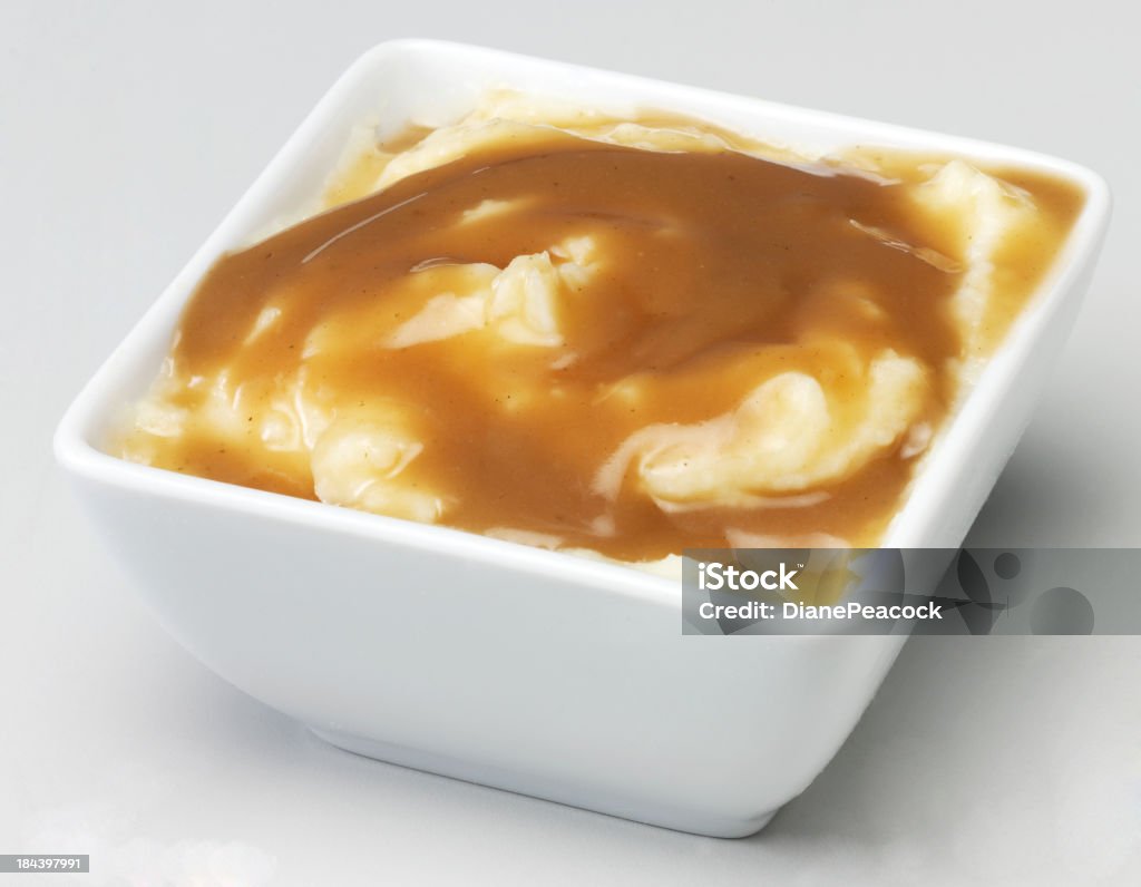 Mash and gravy White bowl with creamy mashed potato and savoury brown gravy Gravy Stock Photo