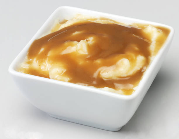 Mash and gravy White bowl with creamy mashed potato and savoury brown gravy mashed potatoes stock pictures, royalty-free photos & images