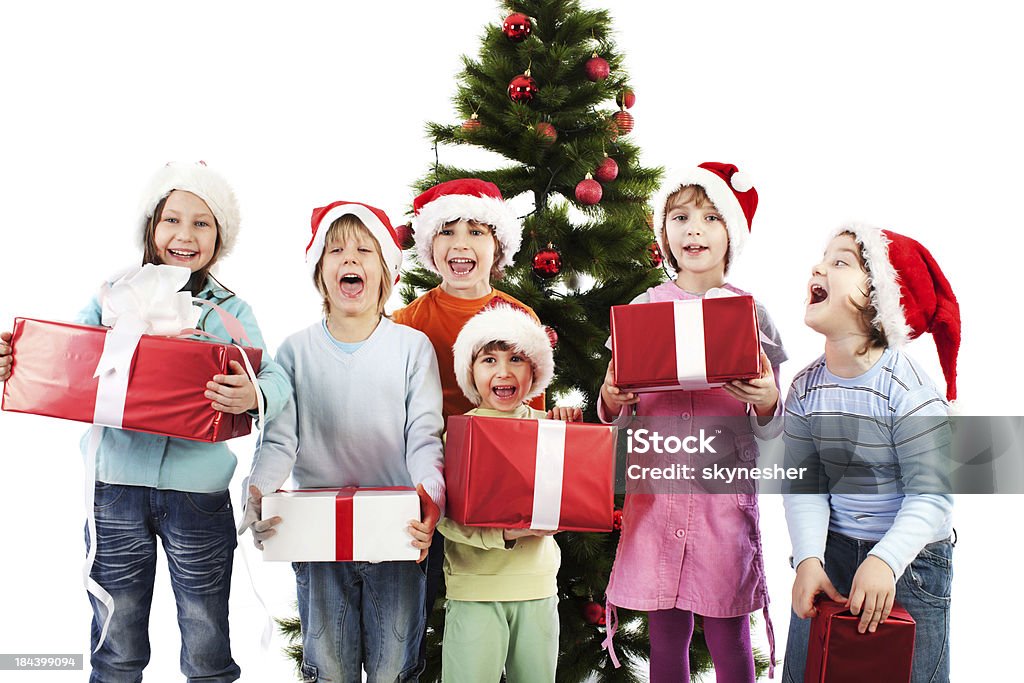 Happy children holding Christmas presents. - Foto de stock de Eufórico libre de derechos