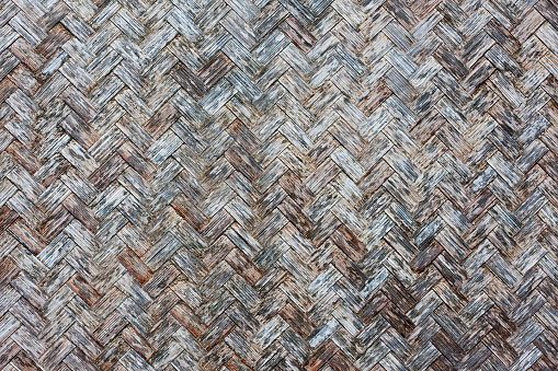 Rustic weathered herring-bone woven reed background.