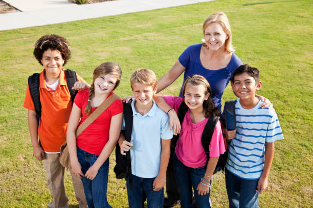 istock Teacher with  group of students outdoors 184399372