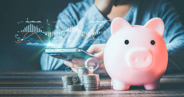 istock Businessmen use internet technology to analyze data graphs for financial planning. The goal is to invest wisely and save money for future expenses. piggy bank saving concept for financial stability. 1843999066