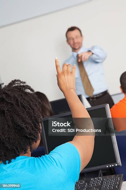 College Student Raising Hand In Class Stock Photo - Download Image Now - Adult, African Ethnicity, Asking